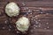 Two chocolate desserts filled with white cream on wooden table, dessert with white hearts for valentines day