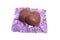 Two chocolate heart candy in puple foil on white background