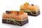 Two chocolate orange soaps with clove, Illicium, cinnamon and loofah on top on white background