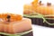 Two chocolate orange soaps with clove, Illicium, cinnamon and loofah on top on white background