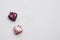 Two Christmas decorations in the form of a pink and plum-colored heart with copy space