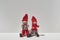Two christmas elfs sitting together on white background. Minimal christmas concept of love