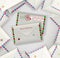 Two Christmas mail envelopes on the pile of another daily, holiday mail envelopes,