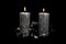 Two Christmas silver candles on the black background