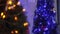 Two christmas trees decorated with blue christmas tree toys and christmas decorations