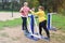 Two chubby girls performs sports exercises on street simulators