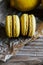 Two citron macaroons on a wooden background