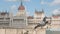 Two city doves are sitting on quay of Danube river in Budapest, Hungarian Parliament Building