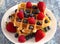 Two Classic Berry Waffles on a Rustic Blue Wood Table