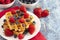 Two Classic Berry Waffles on a Rustic Blue Wood Table