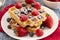 Two Classic Berry Waffles on a Rustic Blue Wood Table