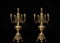 Two classic bronze chandeliers on a black background, ancient candlesticks studio photo, antique bronze candlesticks isolated, bra