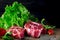 Two classic fresh ribeye steak on stone with herbs peppercorns over grey stone surface background top view