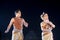 Two Classical Odissi dancers male and female performing Odissi Dance on stage at Konark Temple, Odisha, India.
