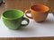 Two clay cups - green and brown