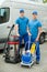 Two Cleaners Standing With Cleaning Equipments
