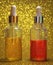 Two clear glass bottles with bright cosmetic oils yellow and red