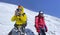 Two climbers in helmets on the way to the top of the mountain