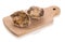 Two closed oyster on a wooden cutting board isolated