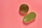 Two closed packagings of canned food on pink background. Top view