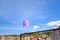 Two clothespin pink and white on a clothesline  on a sunny blue sky