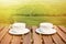 Two coffee cups on the wooden table