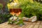 Two cold rose wine glasses served on outdoor terrace in garden with flowers in sunny day