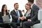 Two colleagues handshaking after meeting.