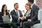 Two colleagues handshaking after meeting.