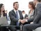 Two colleagues handshaking after meeting.