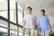 Two colleagues of nursing home walking in hallway