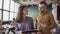 Two colleagues walking through the modern office and talking. Caucasian man and asian woman discussing the documents.