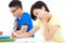 Two college students sitting an exam in a classroom