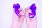 Two-color blue and pink slime in someone\'s hands on a white background. The mucus is crushed  stretched 