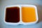 Two color tone of chinese sour and sweet sauce in white cup for dimsum.