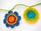 Two Colorful, Crocheted Flowers