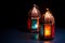 Two colorful oriental Lamp lanterns burn with candles with color