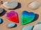 Two colorful stone hearts on beach