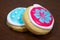Two Colourful Cookies handmade on a wooden surface.