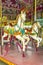 Two colourful horses in a vintage (old fashioned) carousel