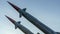 Two combat missiles aimed at the sky. Old ballistic missile launcher on blue sky background
