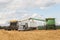 Two combines loading a semi truck with grain