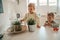 Two concentrated children staring at the houseplants in the kitchen