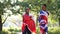Two confident African American young women posing with British and Canadian flags in summer park in sunshine. Beautiful