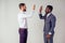 Two confident business men talking high five teamwork international company good deal.afro american and european man in