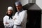 Two confident chefs with hands folded in commercial kitchen. Team of two confident chefs with hands folded in commercial