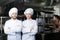 two confident chefs posing in professional kitchen