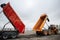 Two construction dump trucks at a special machinery exhibition.