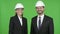 The Two Construction Engineers Smiling While Looking at the Camera Against Chroma Key