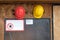 Two construction hard hats on the wall with warning sign